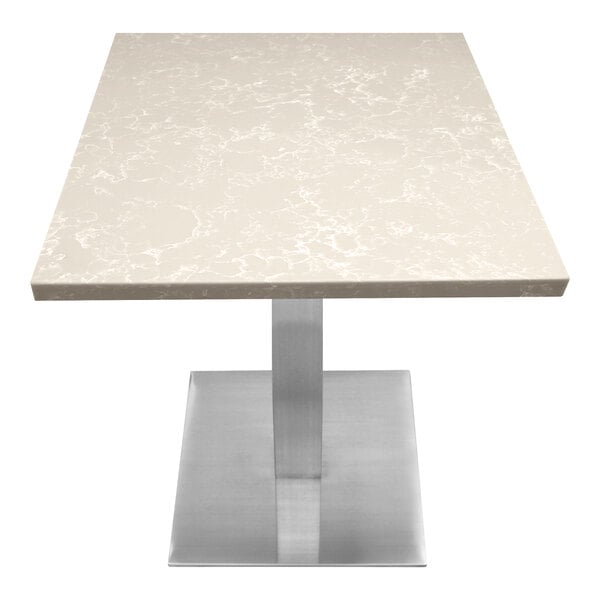 A white quartz table top with gray veining on a metal table base.
