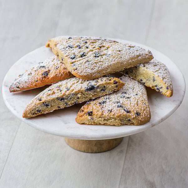 A plate of Rich's blueberry scones with powdered sugar on top.