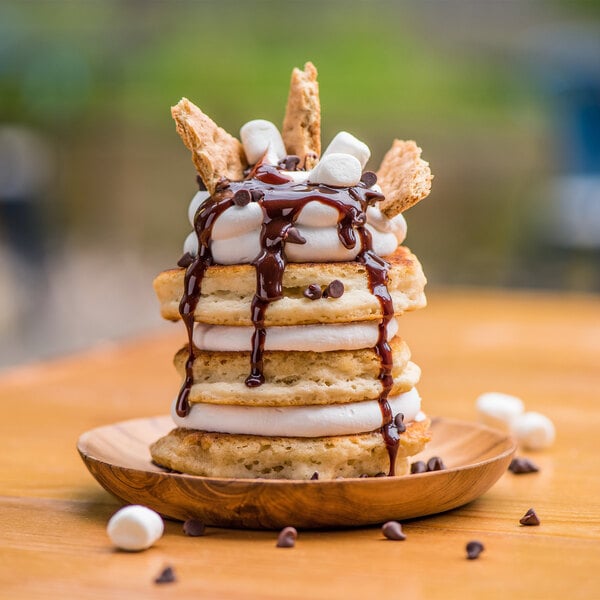 A plate of pancakes topped with Rich's On Top marshmallow dessert, chocolate syrup, and marshmallows.