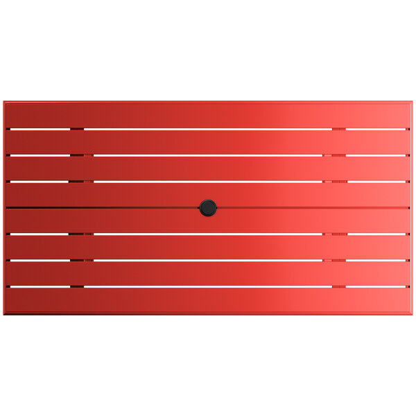 A red rectangular table with a black umbrella hole.