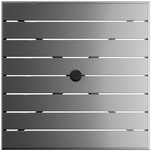 A square metal surface with a black circle.