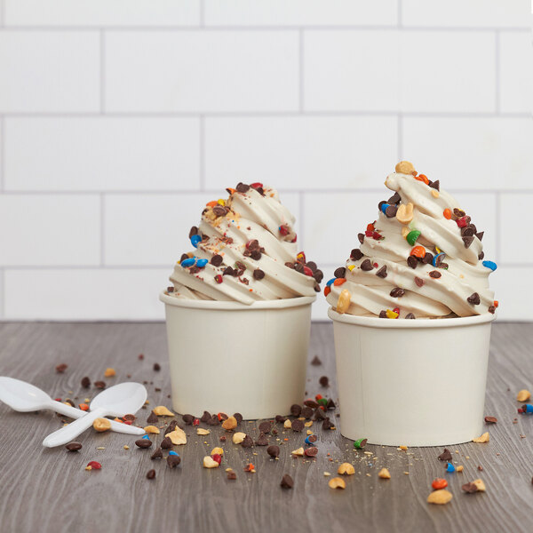 Two cups of Rich's vanilla oat milk soft serve with sprinkles and chocolate chips.