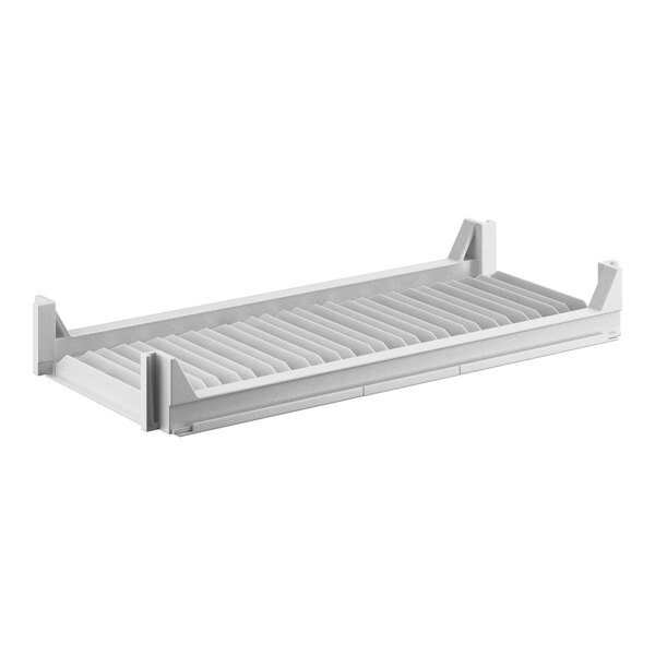 A white shelf with metal slats.