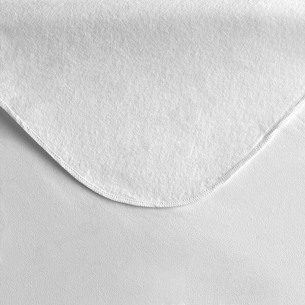 A white vinyl table cover with a flannel backing and a curved edge.