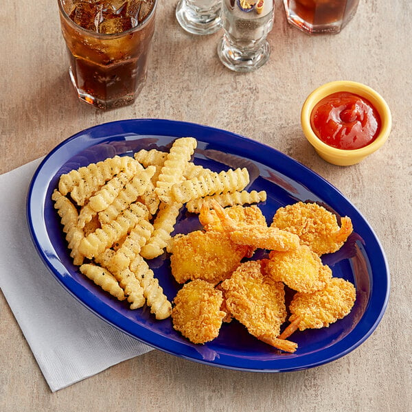 An Acopa Foundations blue melamine oval platter with fried food and fries on it.