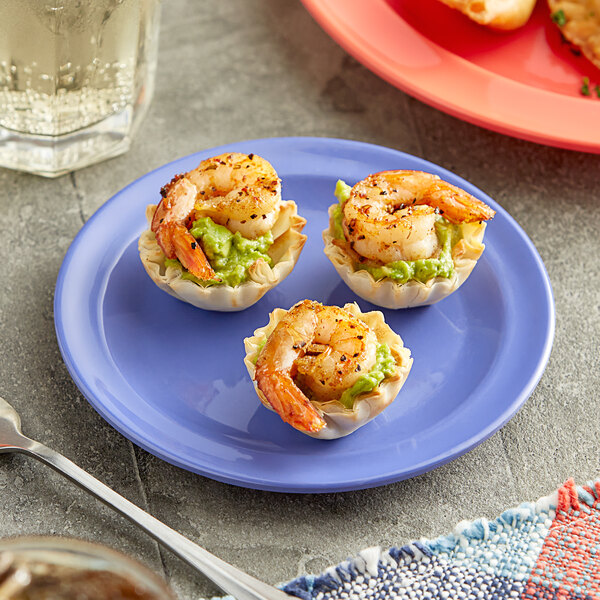 A plate of shrimp and guacamole on a purple Acopa Foundations melamine plate.