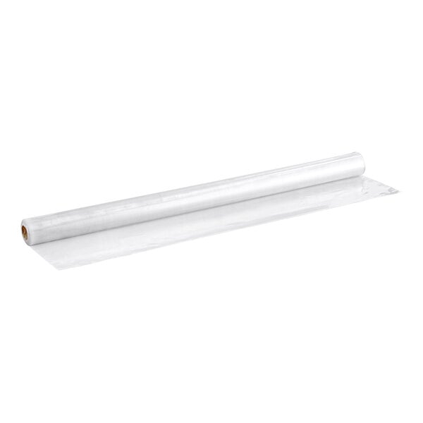 A long roll of clear, flexible material partially unrolled on a white surface.