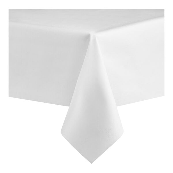 A white, solid-colored table cover draped over the corner of a rectangular table.