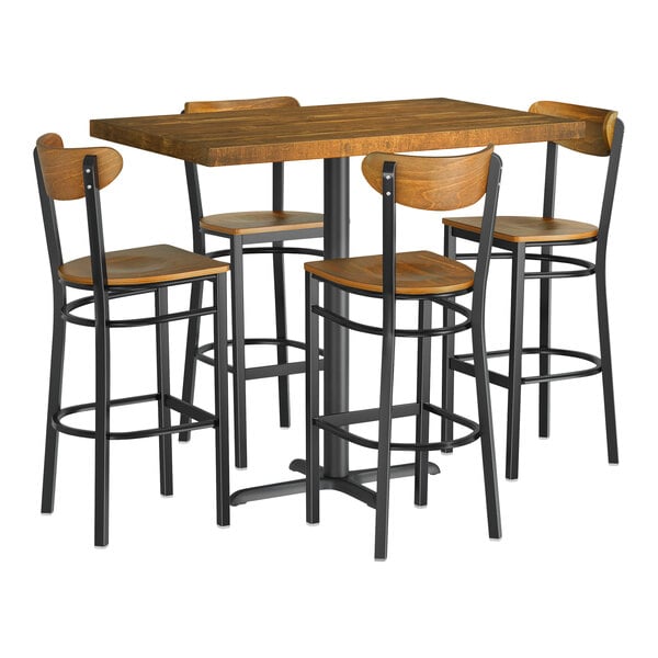 A Lancaster Table & Seating bar height table with a wooden butcher block top and four chairs.