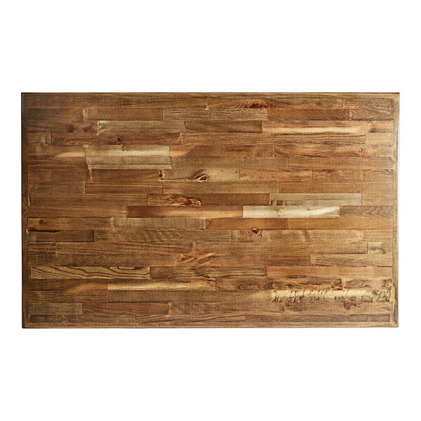 A Lancaster Table & Seating wooden butcher block table top on a wooden table with different colors of wood.