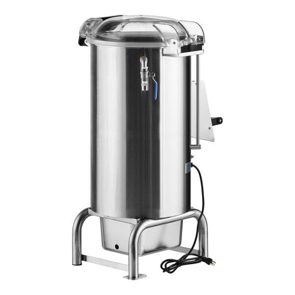 A large, cylindrical stainless steel machine with a clear lid, spout, and attached power cord, standing on four sturdy legs.