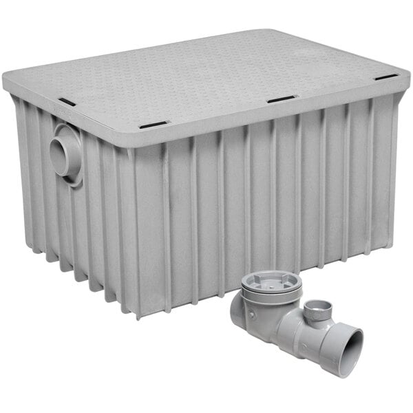 A gray plastic Endura grease trap with a drain pipe.