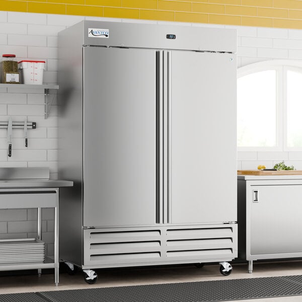 A large stainless steel solid door reach-in freezer with double doors and caster wheels.