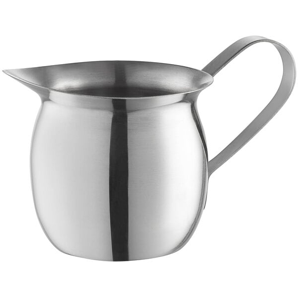 a silver metal pitcher with a handle