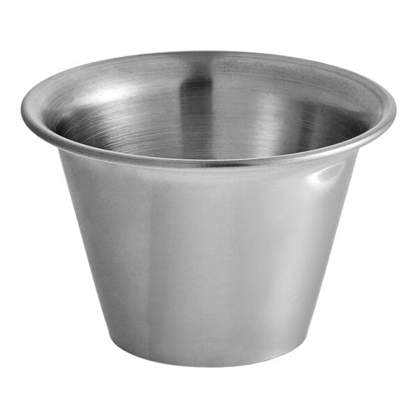 A Vollrath stainless steel round sauce cup.