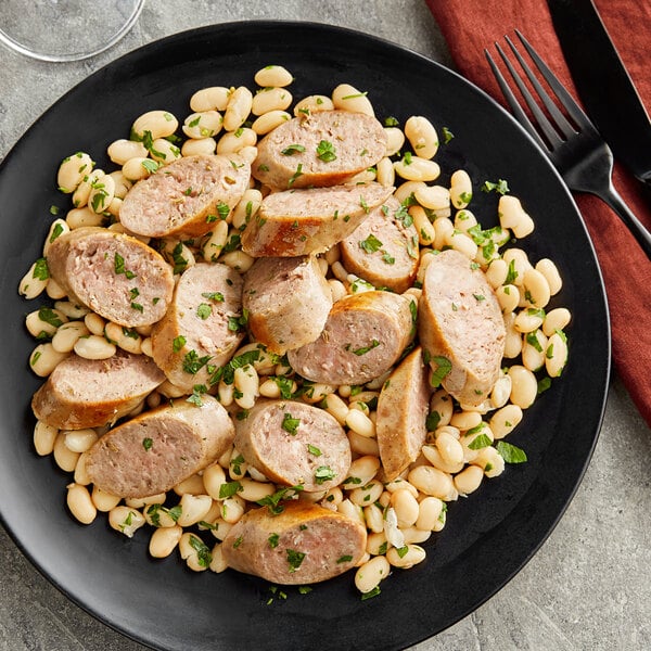 A plate of food with white beans and Warrington Farm Meats Sweet Italian Sausage links.