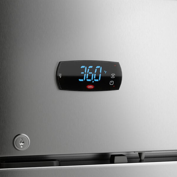 A stainless steel reach-in refrigerator with a digital temperature display on the front.
