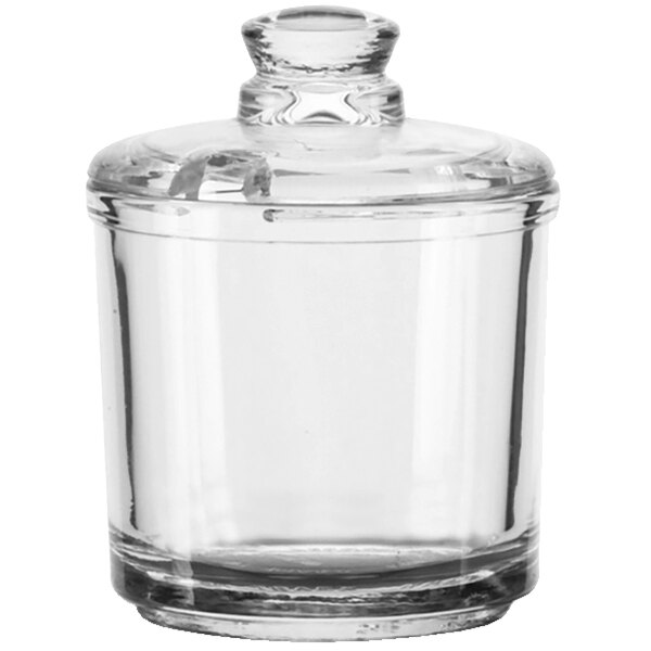 A clear glass Vollrath condiment jar with a lid.