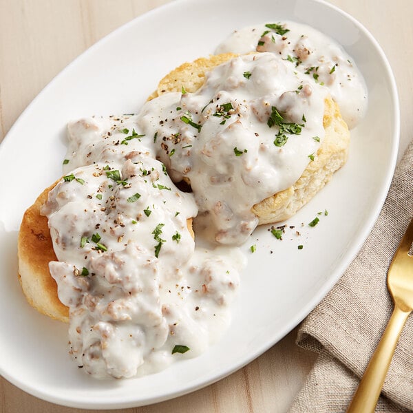 A plate of food with Warrington Farm Meats loose country sausage and gravy with a fork.