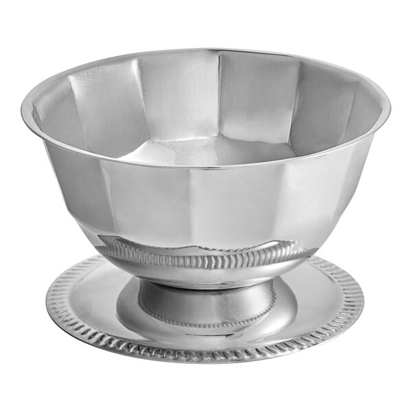A Vollrath stainless steel bowl with a metal rim and gadroon base.