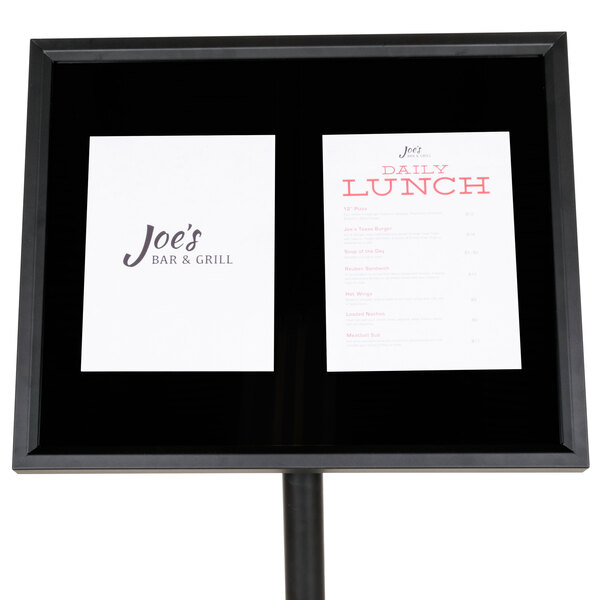 A black frame with a white paper with black text on it.