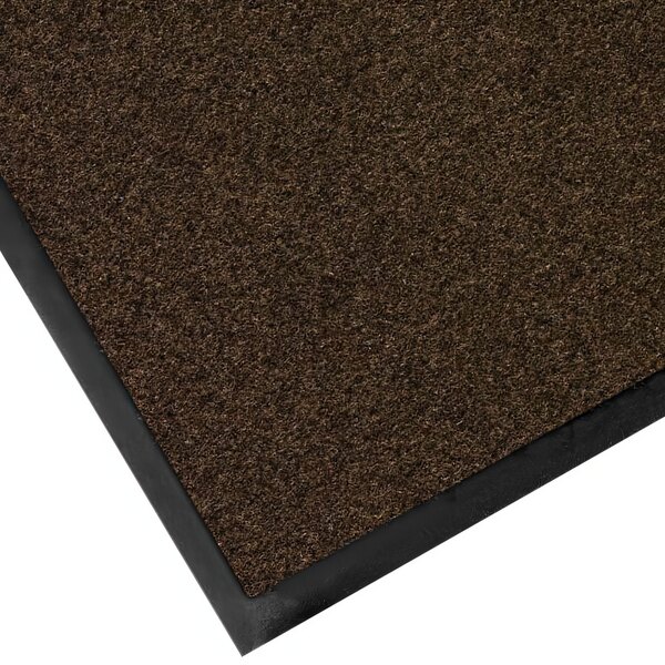 A close-up of a brown Lavex Plush Dilour entrance mat with black trim.