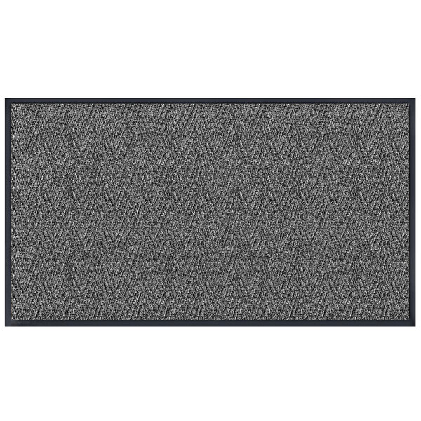 A grey rectangular doormat with a black chevron border.