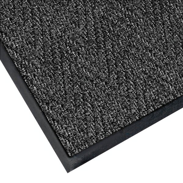 A black, gray, and white Chevron patterned carpet mat with a black border.