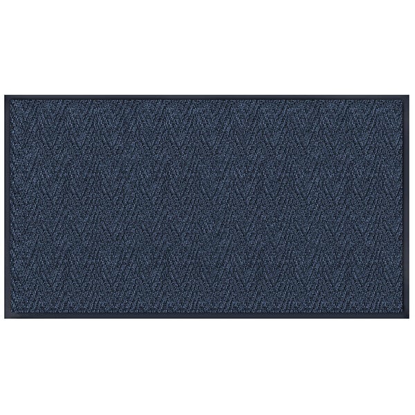 A close-up of a navy blue rectangular carpet with a chevron pattern.