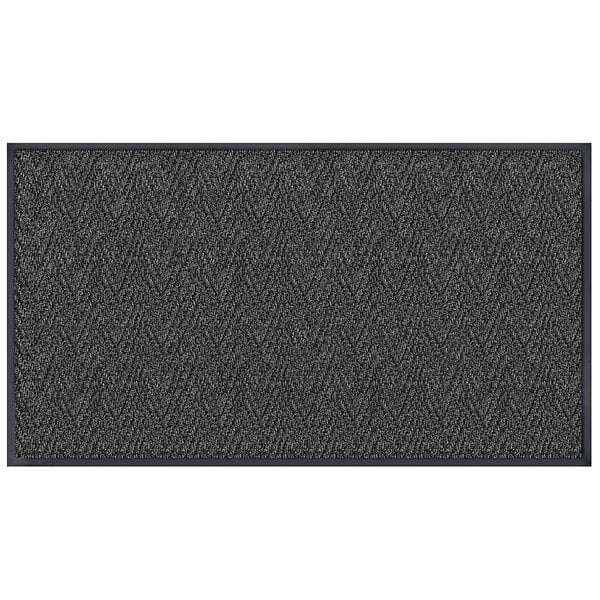 A grey rectangular door mat with a chevron pattern in black.