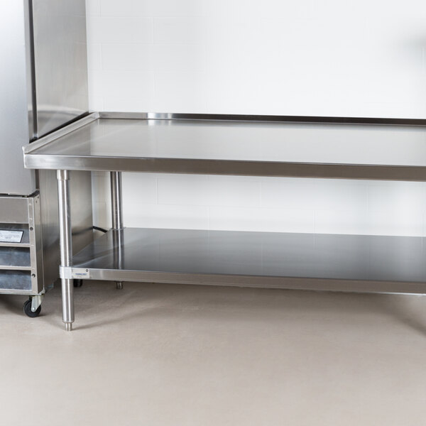 An Advance Tabco stainless steel equipment stand with an undershelf.