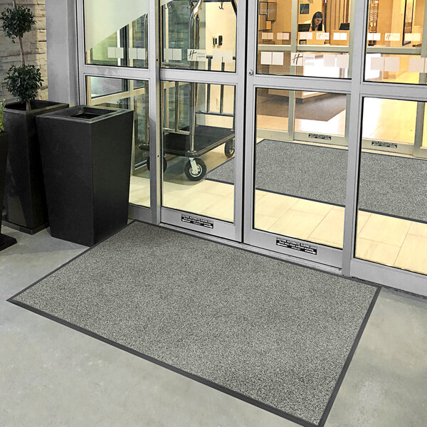 A large door with a gray Lavex Plush Dilour entrance mat.
