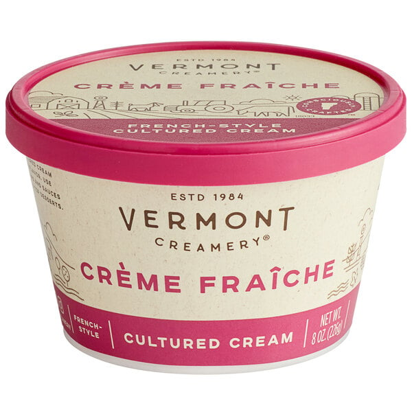 A container of Vermont Creamery Creme Fraiche with a red lid.