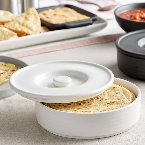 A white Tuxton Tortilla Server with tortillas inside.