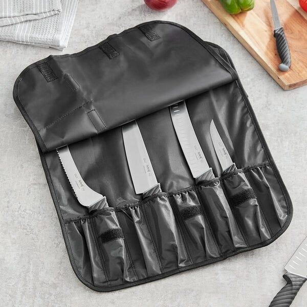 a black canvas knife roll on a table