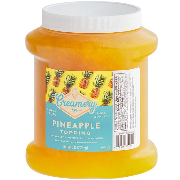 A container of yellow liquid with a label reading "Creamery Ave. Pineapple Dessert"