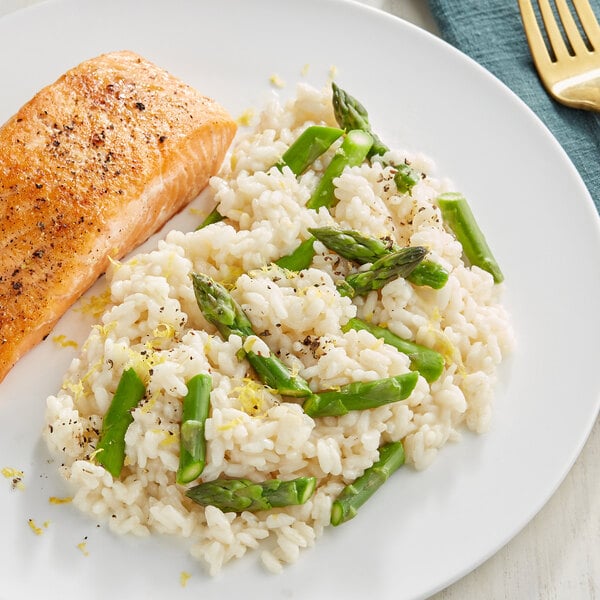 A plate of salmon and Riso Toro Carnaroli rice with asparagus on the side.