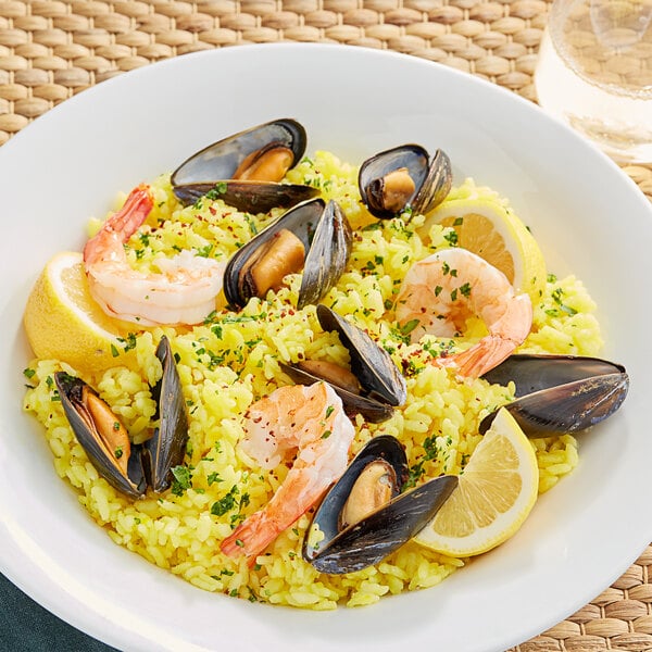 Bomba rice in a Spanish paella dish with shrimp and mussels