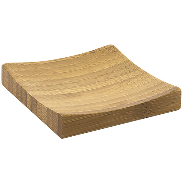 A Front of the House square bamboo plate with a curved edge.