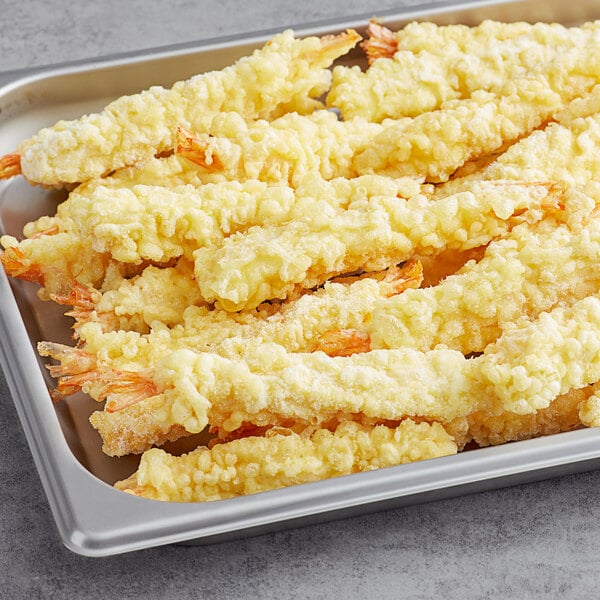 A tray of 16/20 size tempura shrimp sticks.