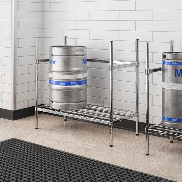 A metal rack with two Regency chrome keg shelves holding metal kegs.