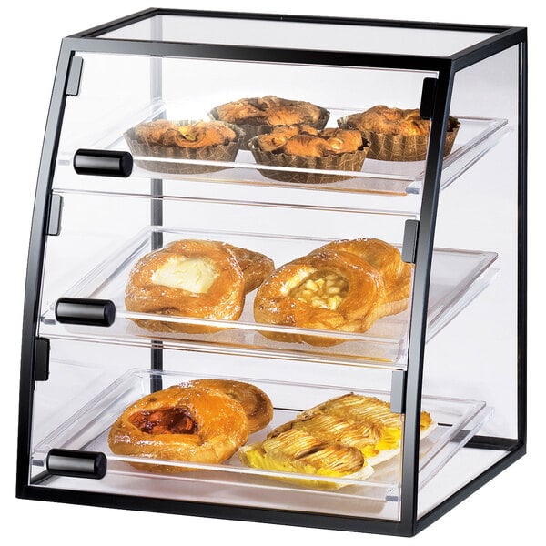 A Cal-Mil curved iron self-service display case with pastries inside.