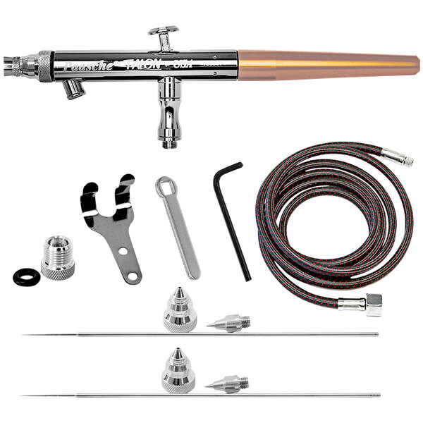 A close-up of a metal and copper Paasche airbrush set.