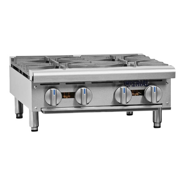 A stainless steel 24-inch natural gas hot plate with four burners and control knobs.