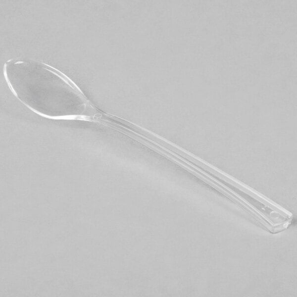 A clear plastic spoon is shown on a plain background.