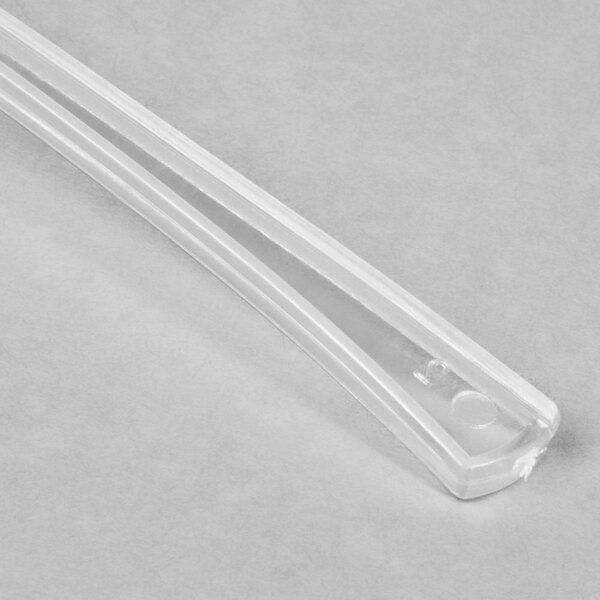 A clear plastic Fineline Tiny Tasters tasting spoon.