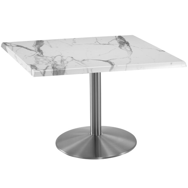 A white marble table with a stainless steel round base.