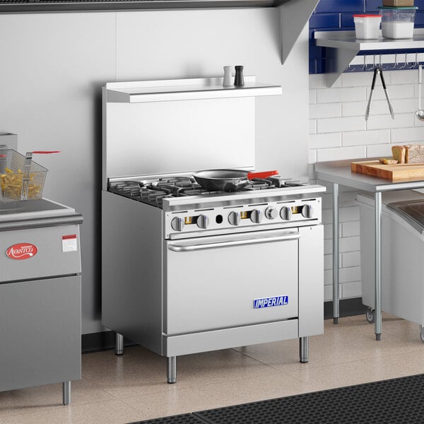 A commercial stainless steel 6-burner natural gas range with an oven, designed for professional kitchen use.