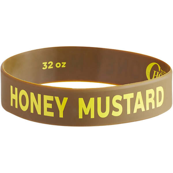 A brown rubber wristband with yellow text that reads "Honey Mustard"