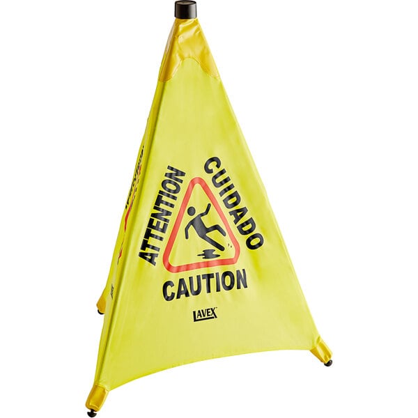 A yellow triangular Lavex caution sign reading "Caution Wet Floor" in a wall-mounted case.